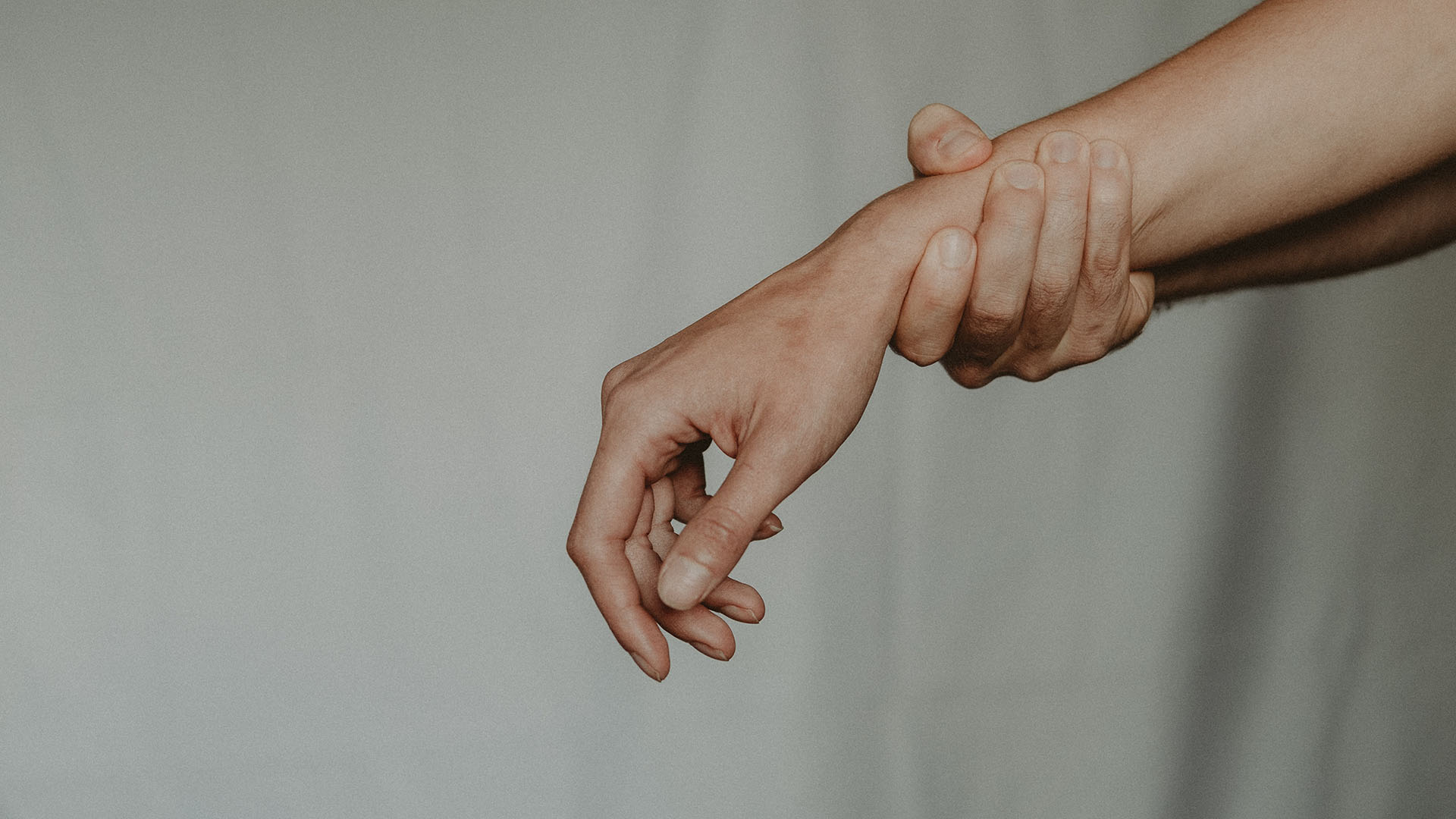 A person's hand holding another person's hand.